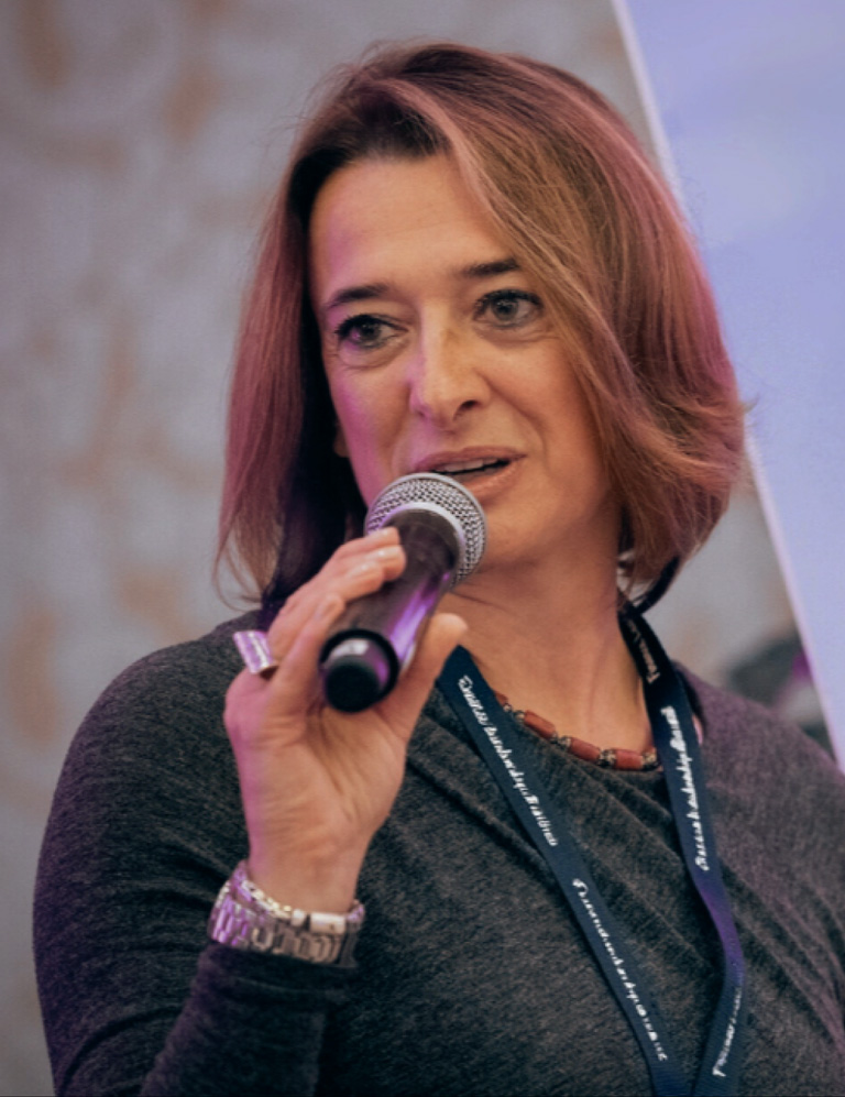 Natasha speaking with microphone